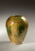 Yellow, brown and green-glazed tsubo with shishi lion design in relief within medallions, 1920&#039;s