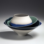 Moon Shadow; Tiered sculpture of one rounded, two shallow, and large conical stacked bowls, fixed into position and decorated with blue, gray, and teal glazes, 2016