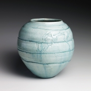 Pale blue-glazed vase with carved concentric bands and two frolicking water sprites, ca. 1958