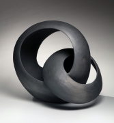 Black sculpture of two interlaced loops, 2018