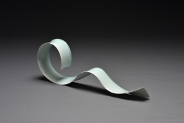 Kino Satoshi (b. 1987), Oroshi 17-5; Thin, elongated, celadon-glazed semi-circular sculpture with a curled end&nbsp;and a wave in the middle